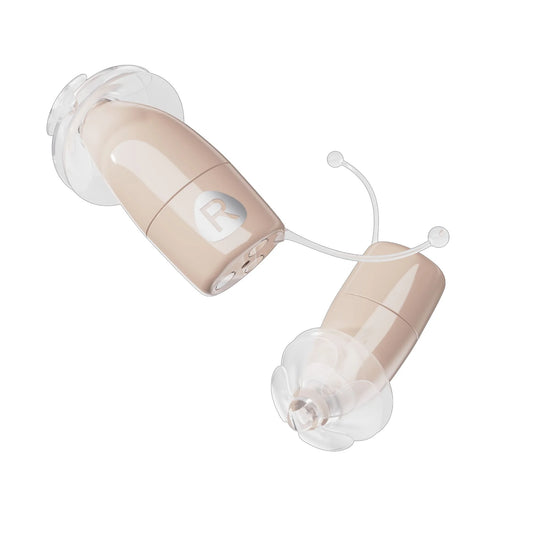 Beige hearing aids on a white background