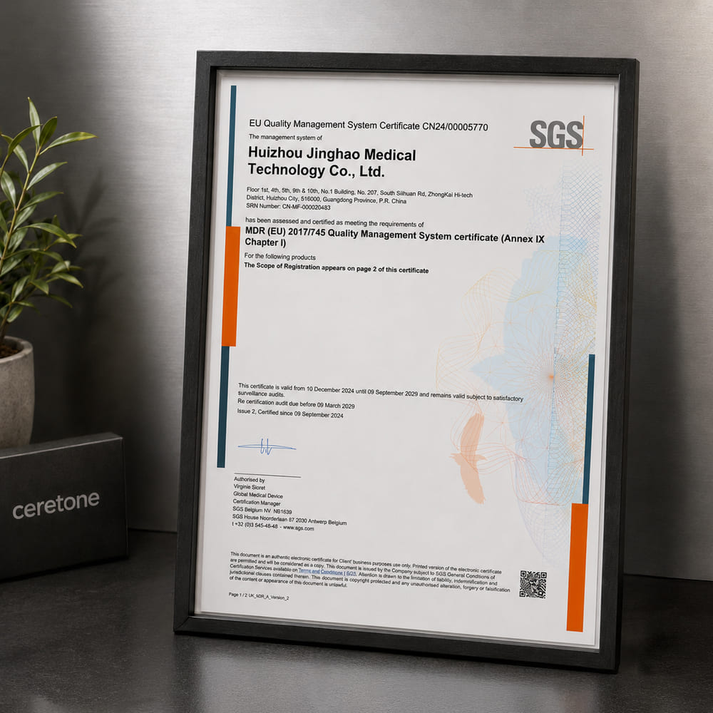 Framed certificate from SGS on a desk with a plant and box in the background